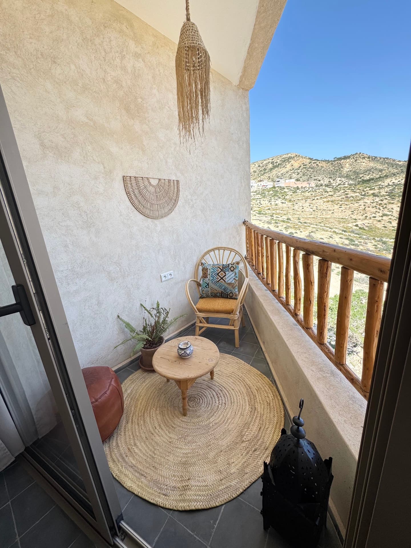 Private balcony with mountain view and rattan furniture