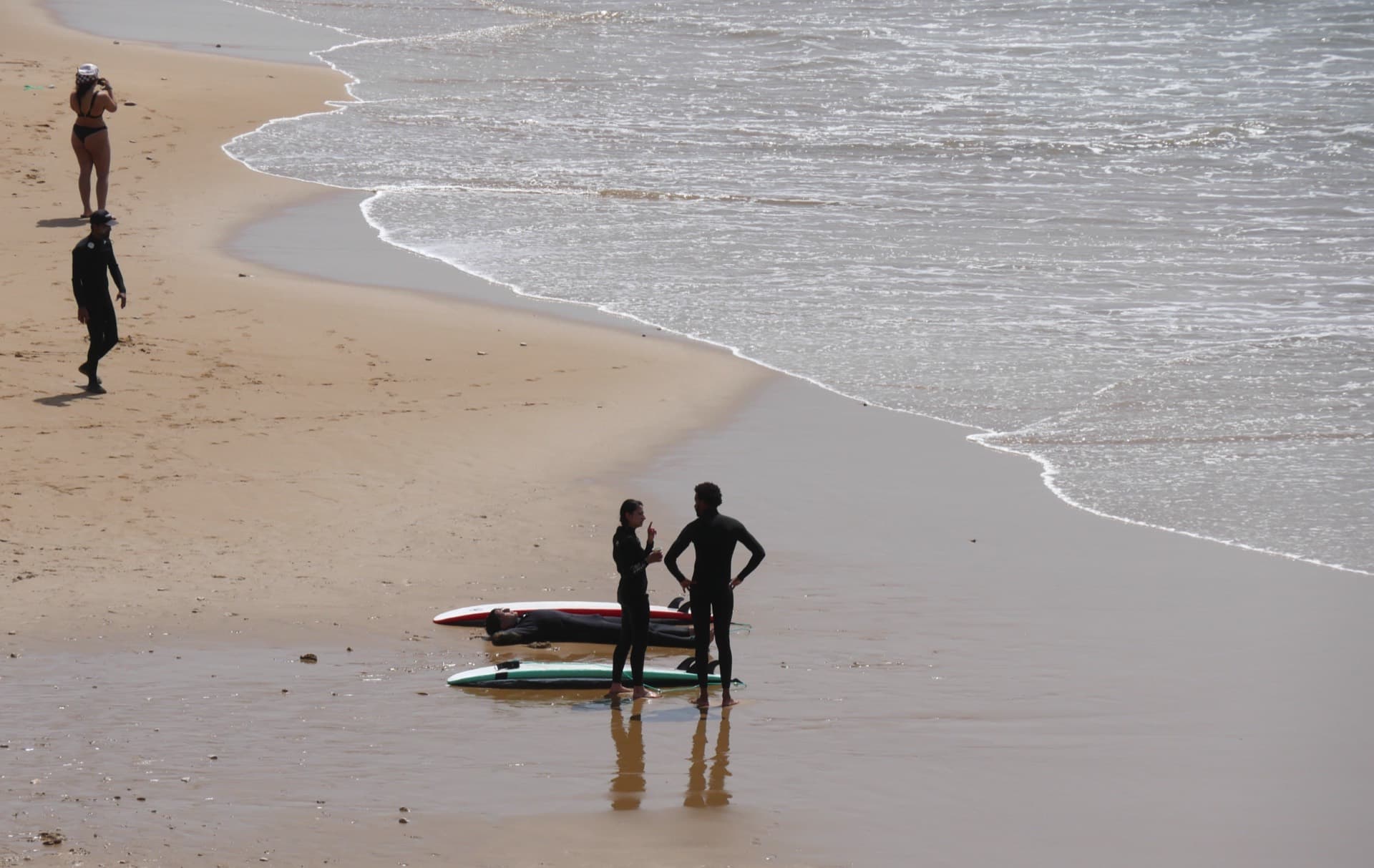 Surfers on the beach in golden hour
