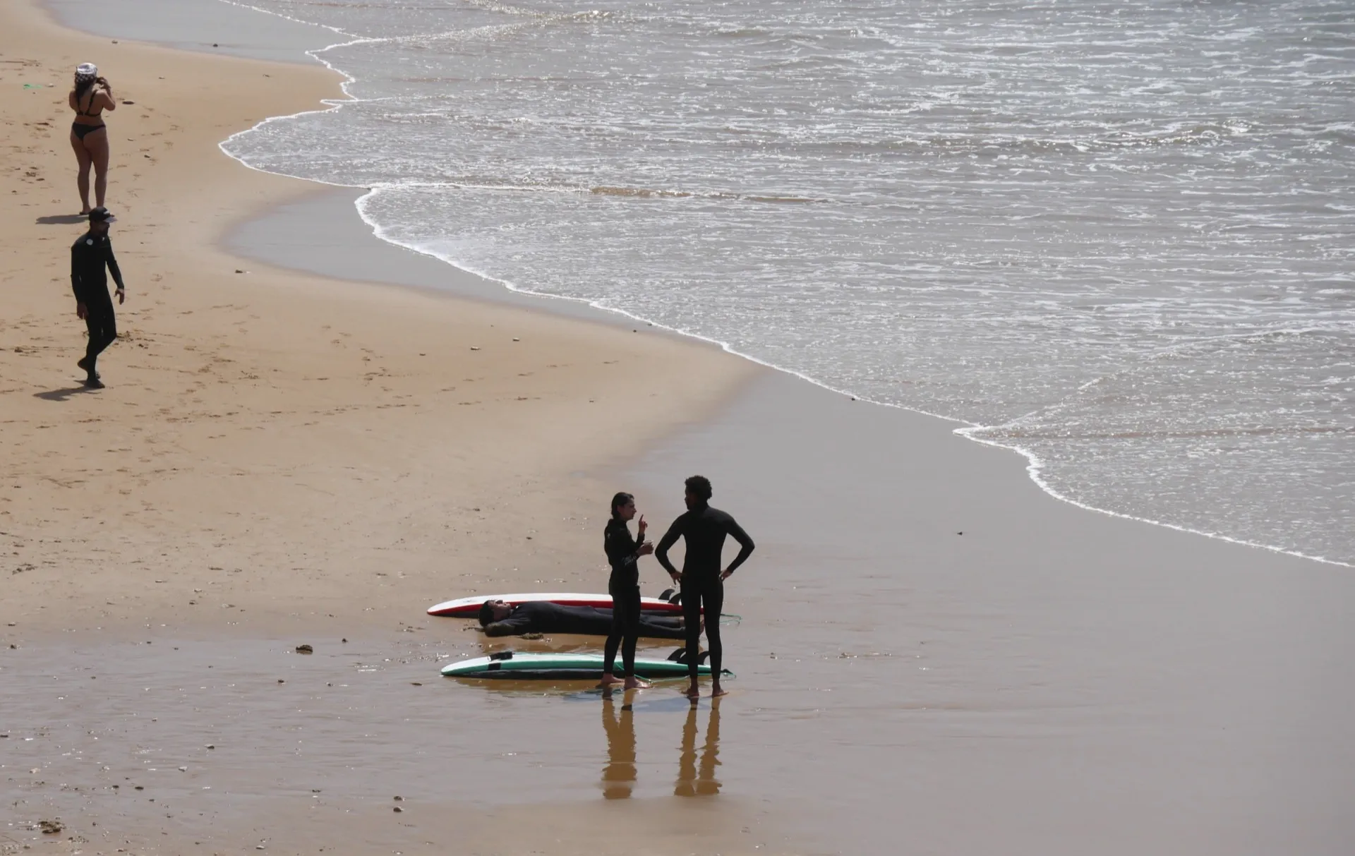 Surfers on the beach in golden hour