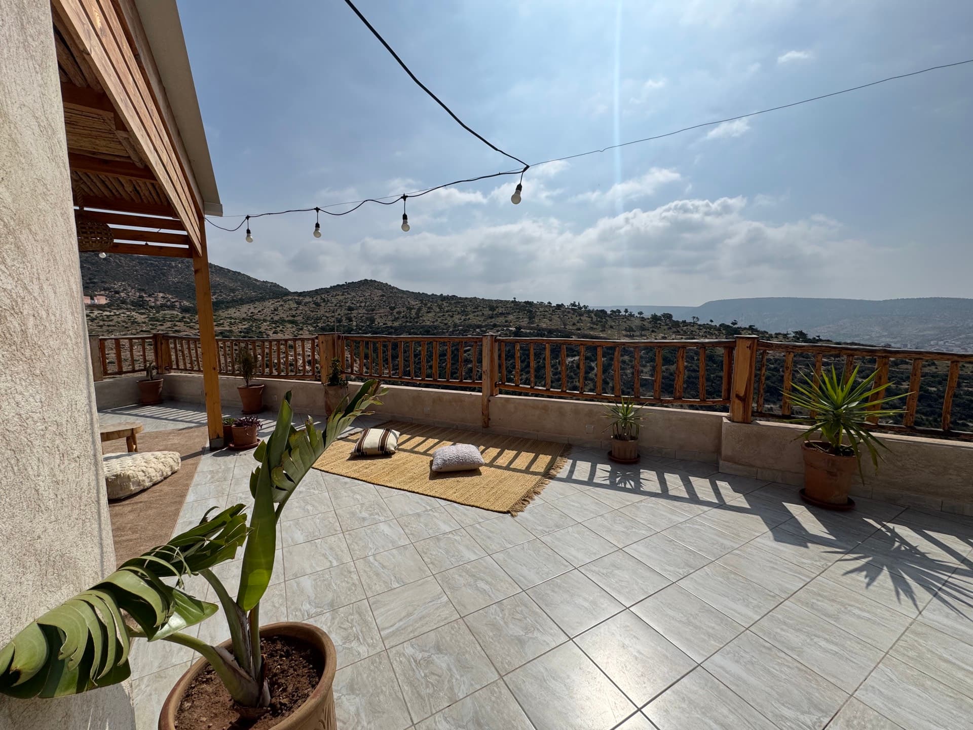 Open rooftop terrace with mountain backdrop